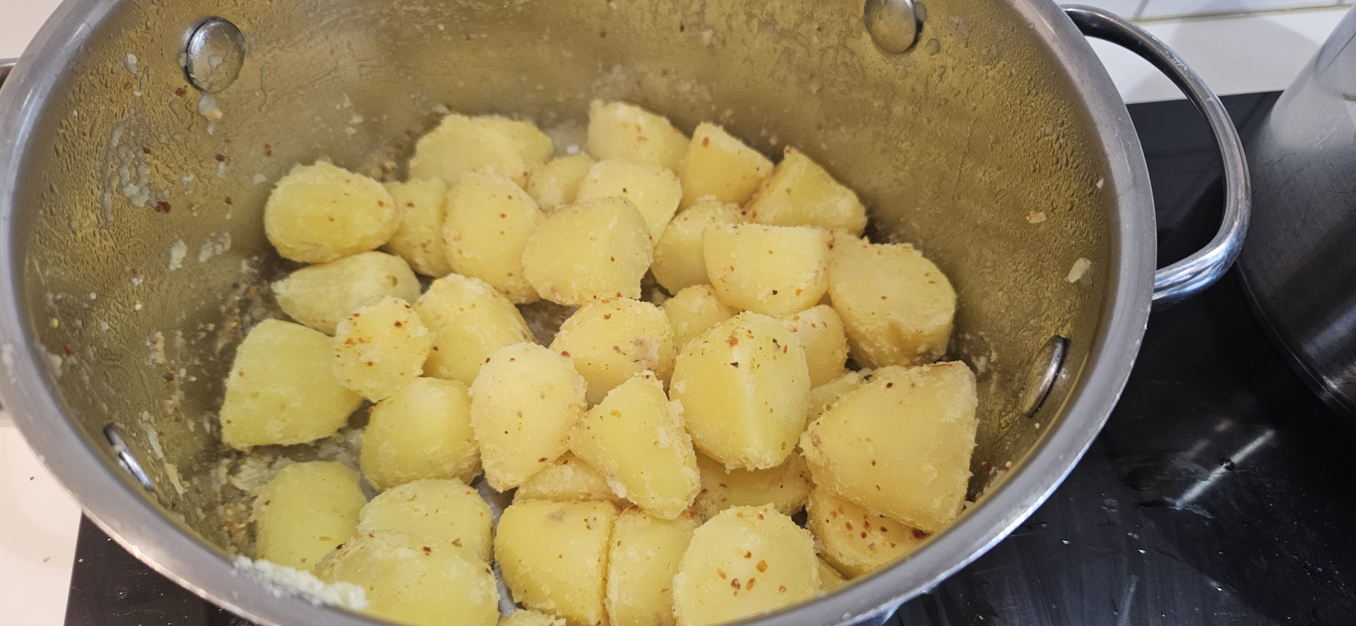 Parboil the potatoes, rough them up in the bowl, and season so the surface turns deeply crisp in duck fat.