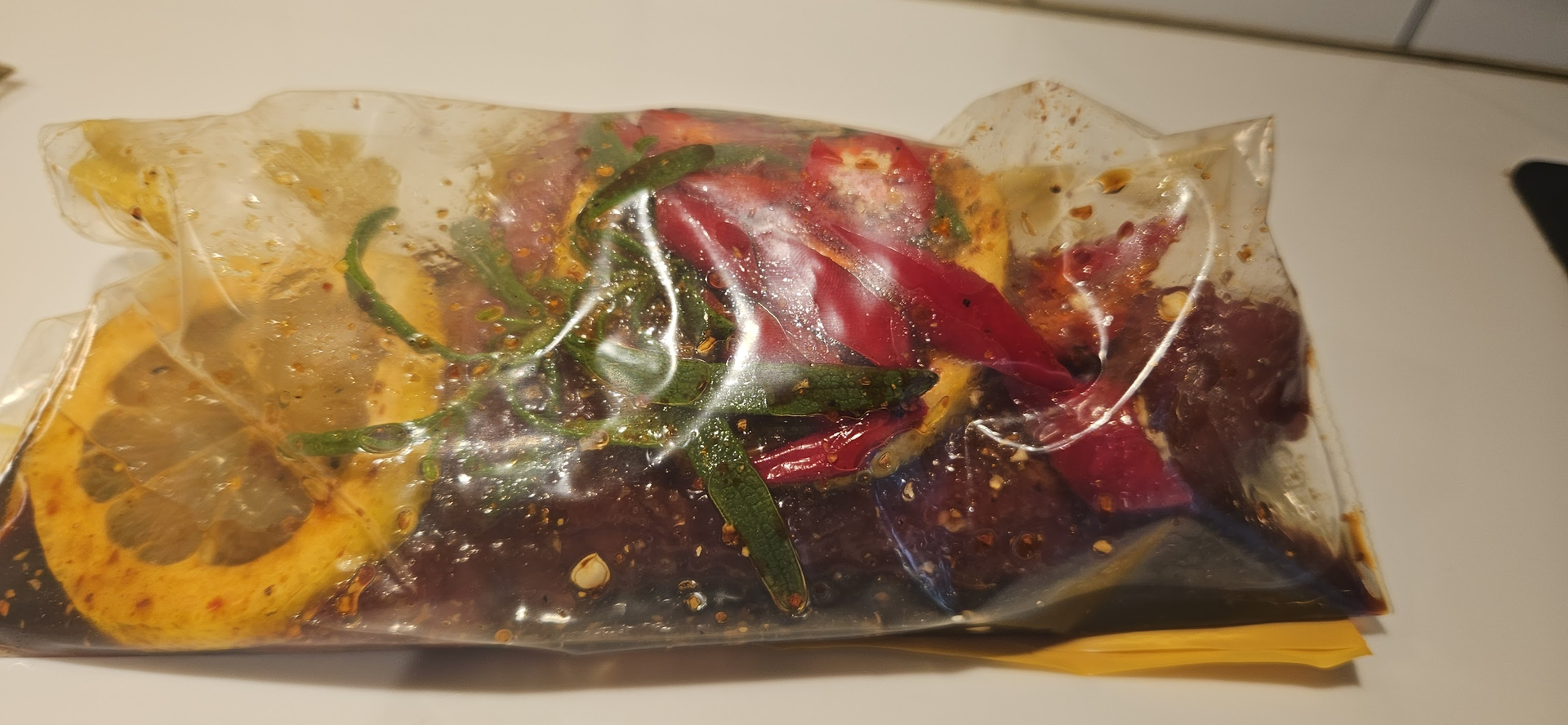 Marinate the meat with soy sauce, lemon, rosemary, and chili while the rest is prepared.