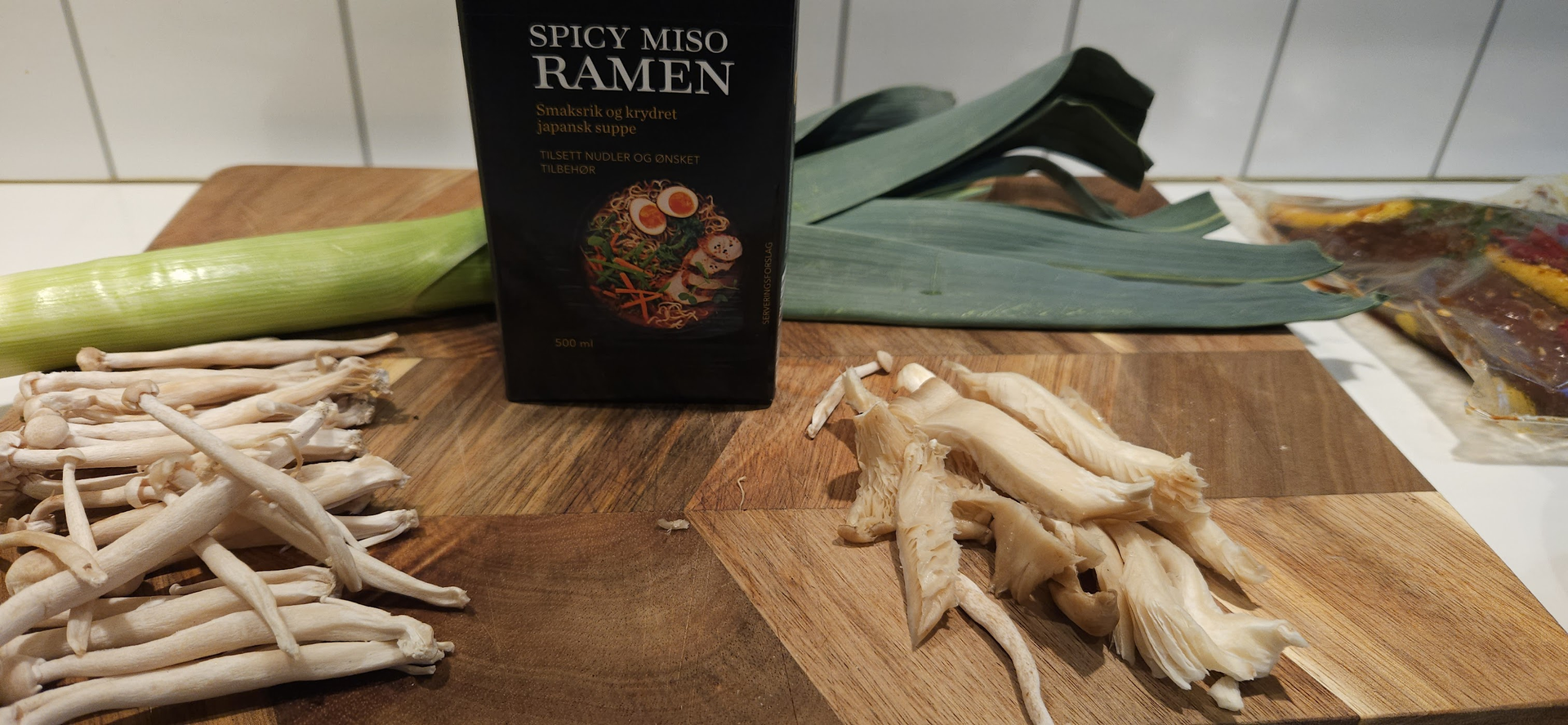 Set out the miso, leek, shimeji, oyster mushrooms, and cabbage before cooking starts.