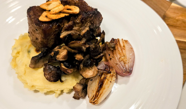 Zebra steak with garlic mashed potatoes, onions, and mushrooms